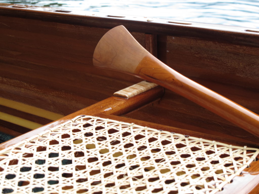 Detail of canoe seat and paddle